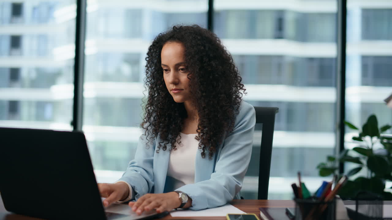 Portrait businesswoman typing laptop sitting office. Woman working on computer.