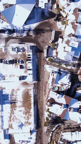 vertical aerial view, tahoe ski resort and palisades olympic village buildings on sunny winter day, california usa