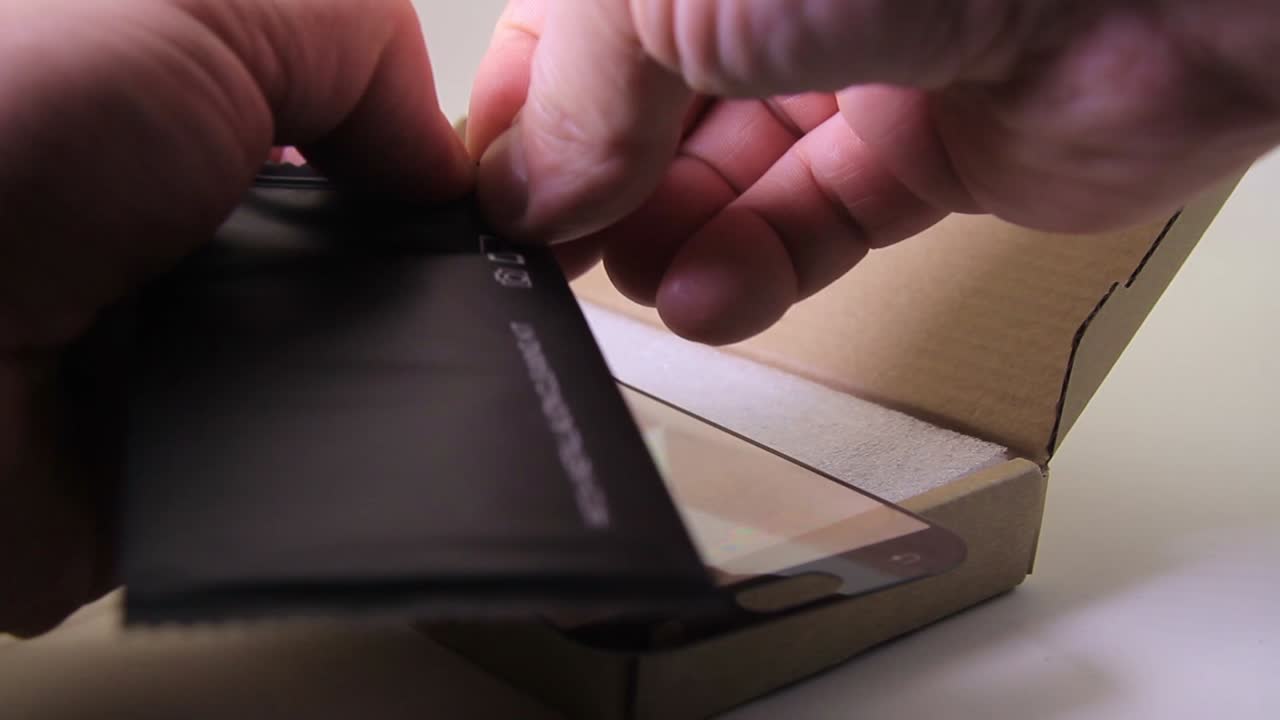 Male Opens a Phone Screen Cleaning Kit