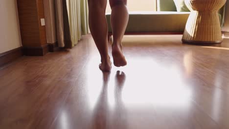 person walking barefoot on a wooden floor