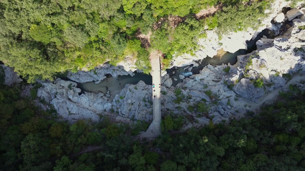 Drone rises over Dala Bridge and the rocky bed of Acheron River in Greece