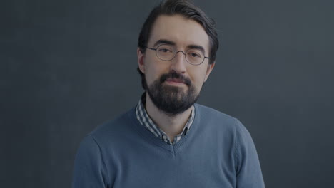 smiling man with glasses and a thumbs up