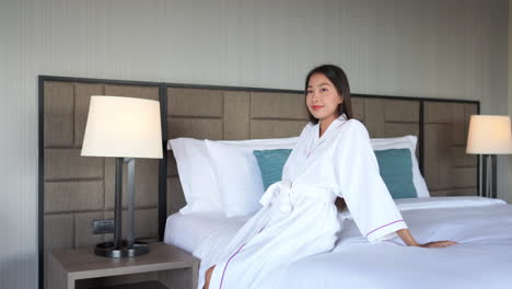 independent asian lady in bathrobe enjoying in a luxurious hotel