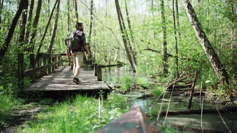 Hiker exploring a dock in the forest of copenhagen