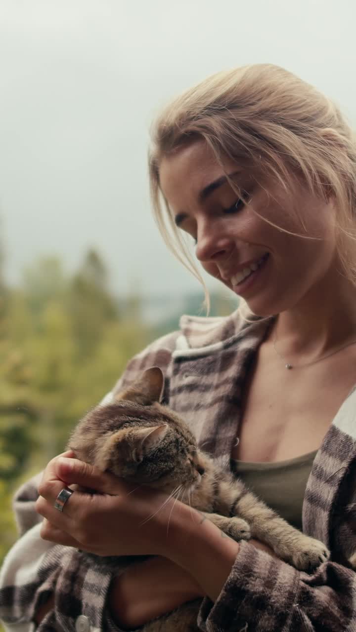 Woman holding a cat outdoors