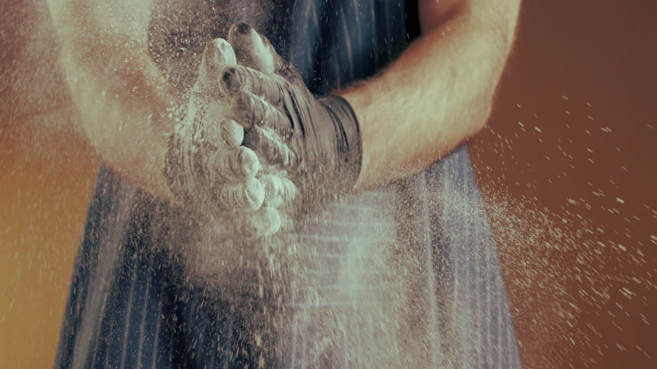 Man clapping hands with flour