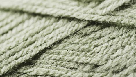 micro video of close up of green woolly threads with copy space