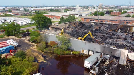 crawler cranes work to clear the damaged factory in the aftermath of a chemical fire