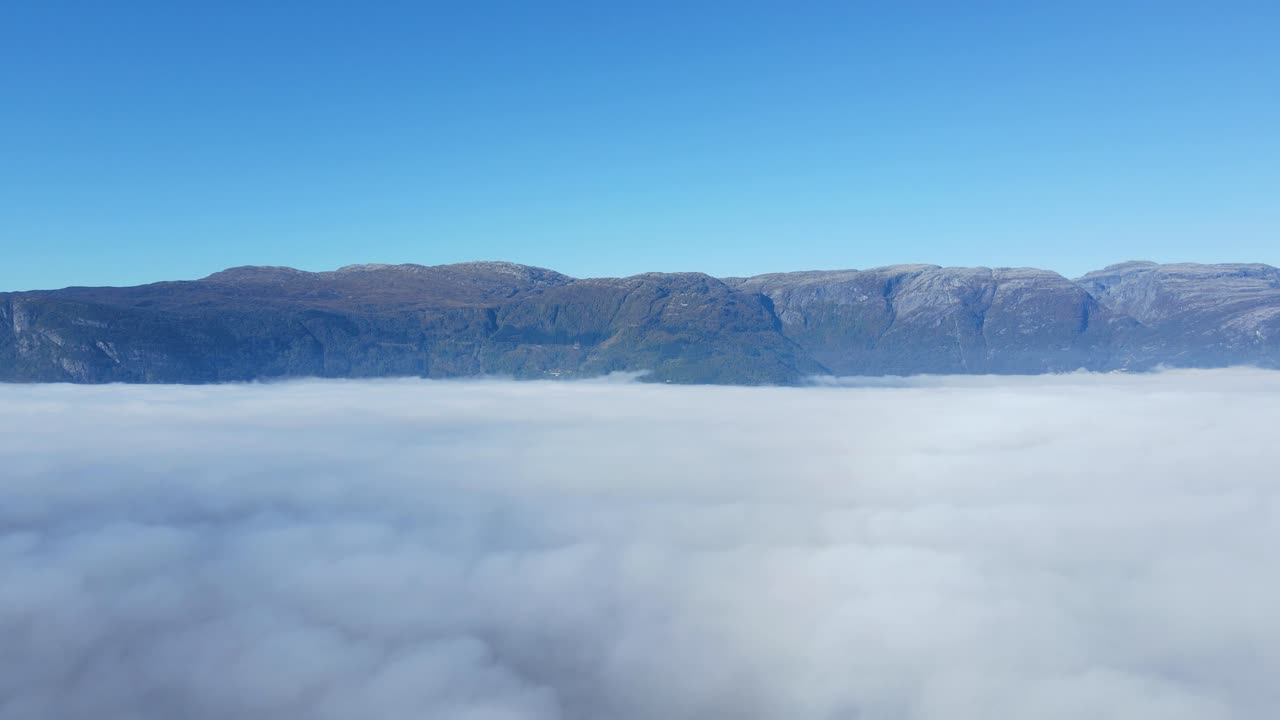 Drone footage of Hardanger fjord covered by mist