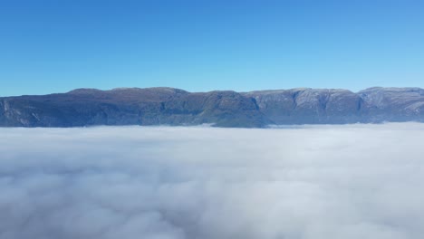 drone footage of hardanger fjord covered by mist