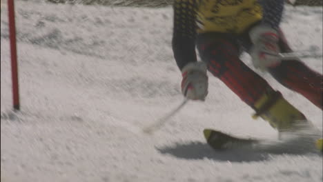 a skier cuts around a downhill slalom