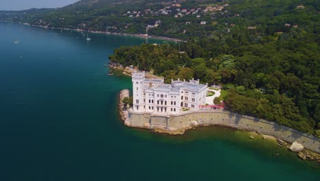 through the lens of a drone camera, one can appreciate the majestic beauty of miramare castle, elegantly perched by the sea