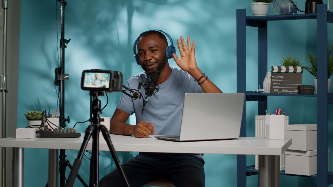 Vlogger recording video on camera with tripod in studio