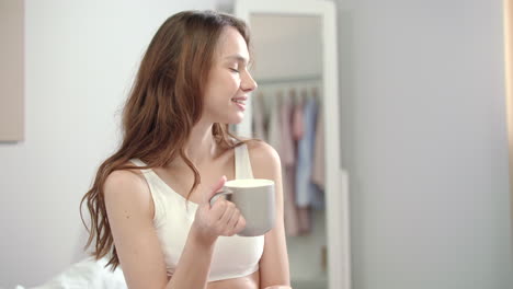 happy woman drinking tea at morning. portrait of young woman enjoy cup of coffee