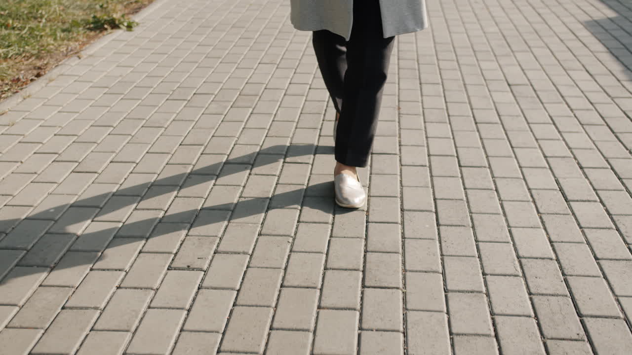 Woman walking on a paved path