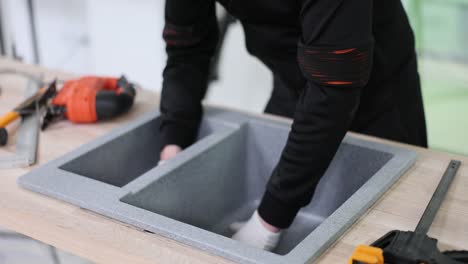 professional installation of a double kitchen sink into a countertop