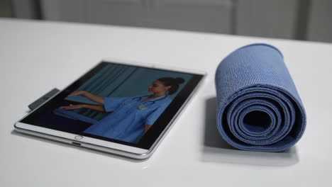 tablet with doctor image and yoga mat