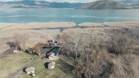 A-rotating-drone-shot-of-a-tropical-mountain,-warm-weather,-flying-above-a-dreamy-village-hill,-4K-video,-European-winter-nature,-scenic-white-clouds,-beautiful-landscape,-clear-water-lake