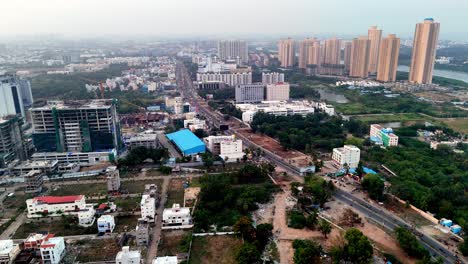 aerial view of a urban landscape chennai, india. mix of developed and developing areas, with modern high-rise buildings in the distance contrasting with low-rise residential structures water body