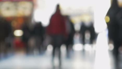 People-walking-indoor-against-bright-light