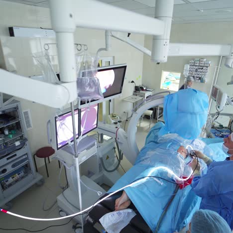 patient uduring surgery at hospital. cooperative diverse team of surgeons perform surgical procedure in operating room