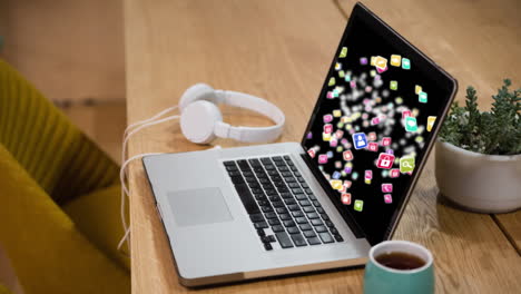 animation of a laptop showing social icons floating and spinning on the screen