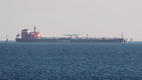 cargo ship moving steadily across the ocean