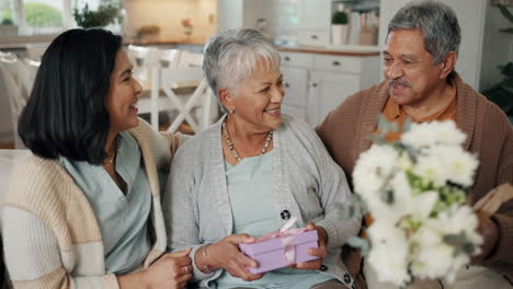 Birthday,-flowers-and-senior-parents-on-sofa