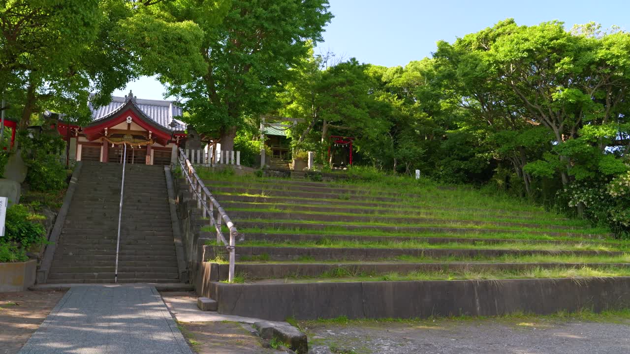 Serene Japanese Temple with Stone Staircase and Green Terraces