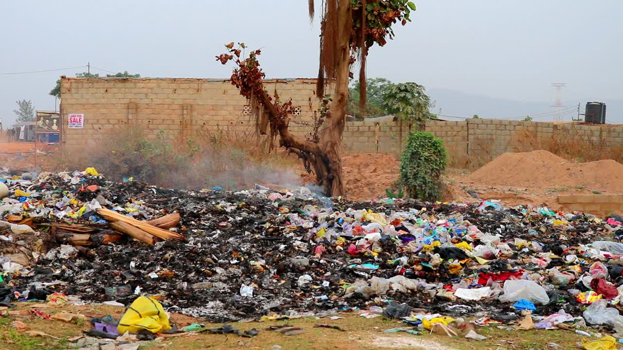 Smoking refuse dump, an environmental pollution. Different angle of view.