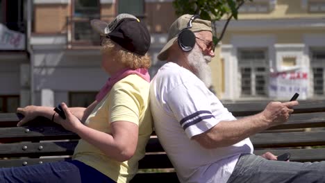 stylish mature woman and mature man relaxing on the bench