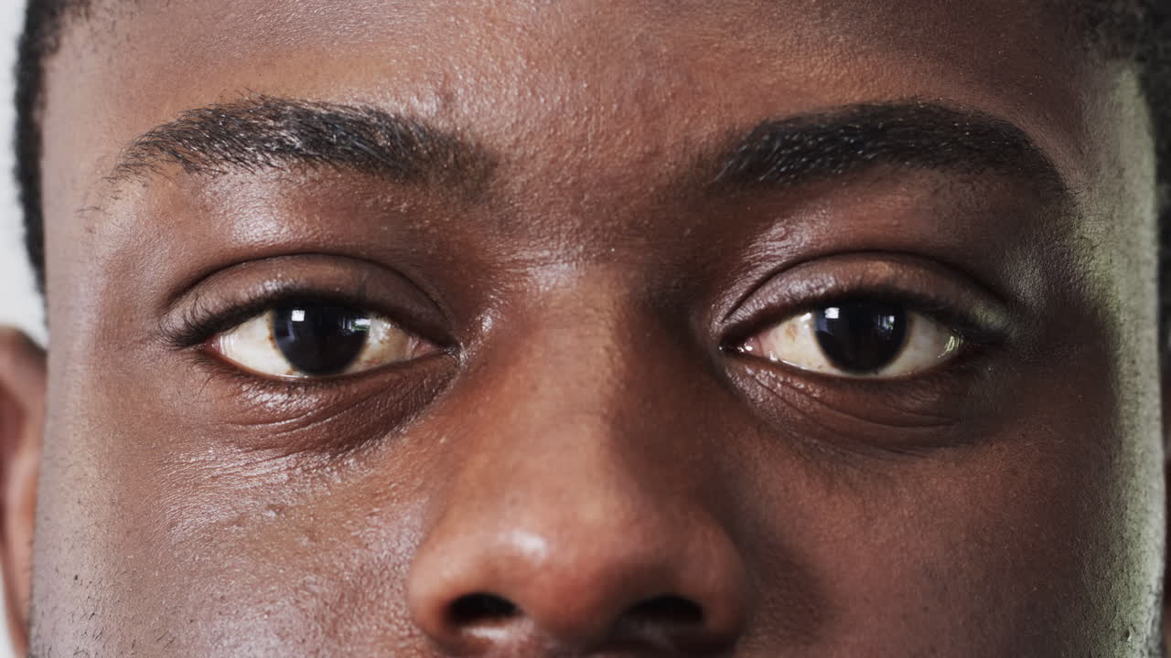 Man's eyes focusing intently, capturing thoughtful expression in close-up shot