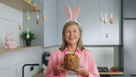 woman holding easter bread with bunny ears