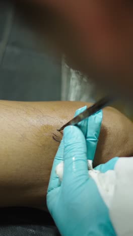 tattoo being applied on a leg