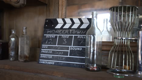 clapperboard an empty glass bottles display inside the saloon in pioneertown, california