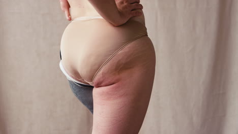 Close-Up-Rear-View-Of-Woman-With-Prosthetic-Limb-In-Underwear-In-Studio