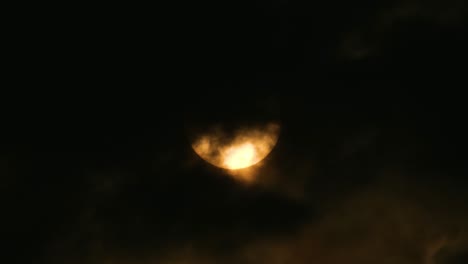 Gelber-Mond-Oder-Gelbe-Sonne,-Die-Sich-Langsam-Durch-Dunkle-Wolken-Offenbart