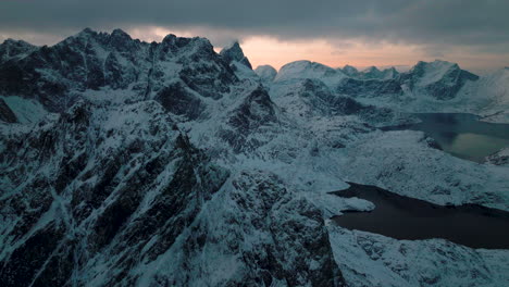 frozen alien lofoten svartvatnet head jagged mountain range terrain aerial view flying towards ghostly cold valley