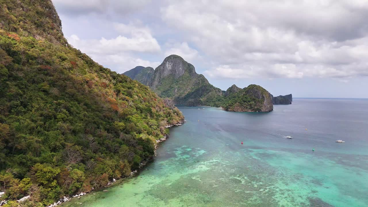 Drone view of El Nido's iconic karst formations, vibrant coral reefs, and clear tropical waters along the northern coast of Palawan, Philippines—famous for its biodiversity and natural beauty