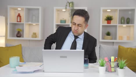 home office worker man itching with allergies.