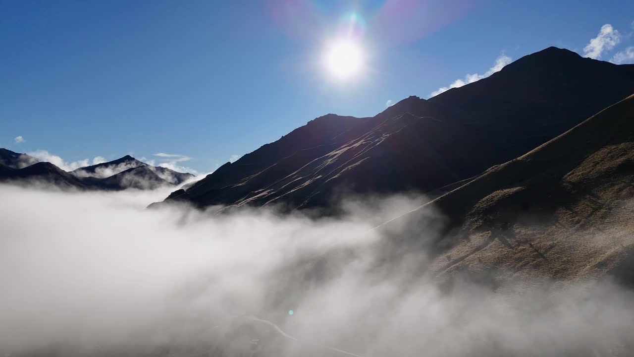 Aerial view of Queenstown mountains at sunrise, with mist and clear skies. Captured in crisp winter air, showcasing natural beauty