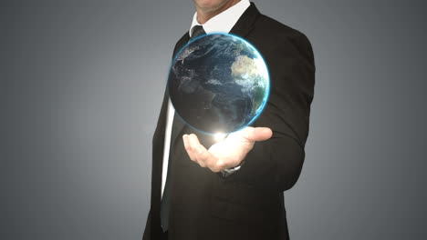 businessman holding digital generated globe