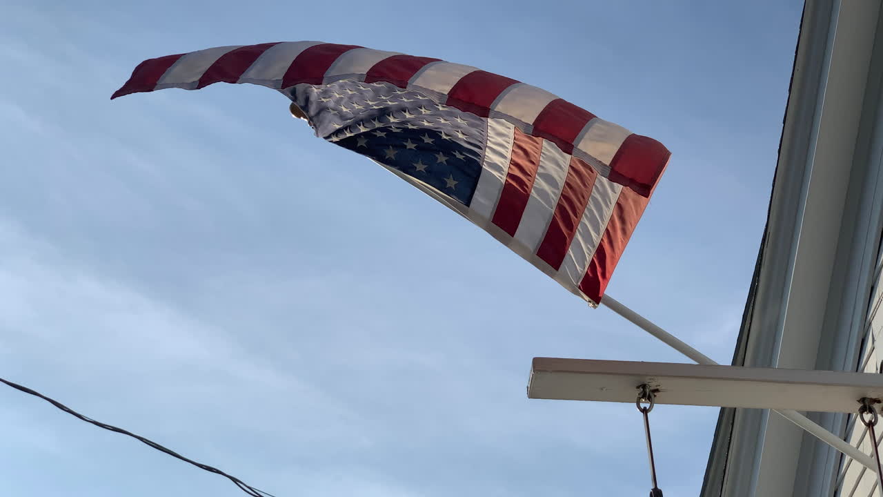 view underneath an American flag blowing gently in the breeze
