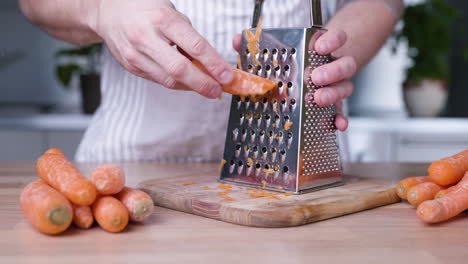 grating carrot in the kitchen for baking cake