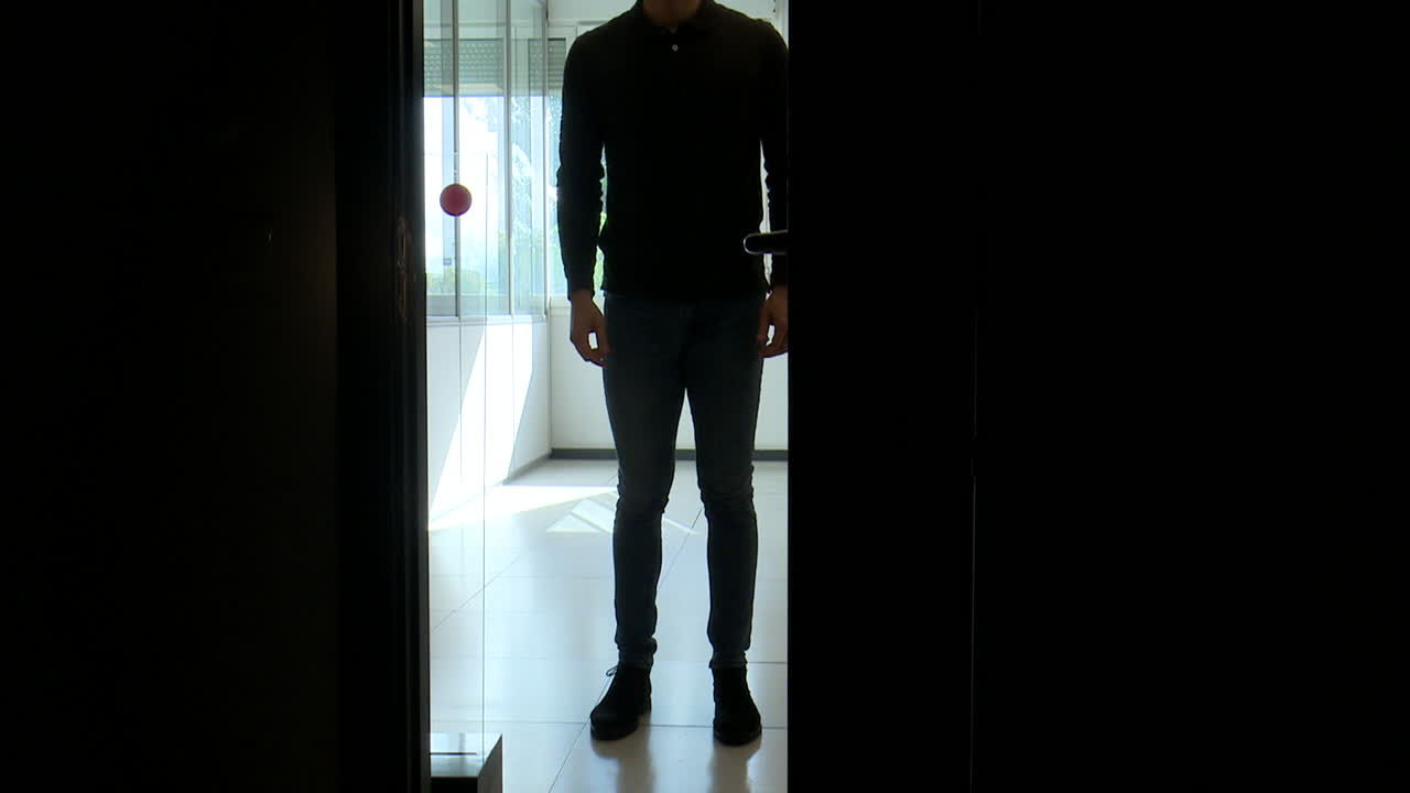 Person Opening a Door in a Dark Room