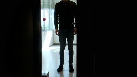 person opening a door in a dark room