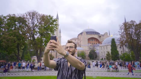 The-man-taking-a-photo-with-the-phone.