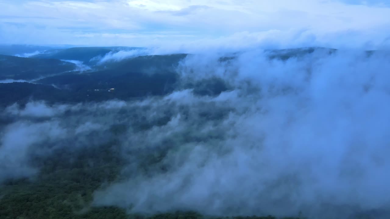 Aerial drone video footage of low clouds over the Appalachian mountains during summer. This is in New York's Hudson Valley on Shawangunk Ridge, which is a sub-range of the Appalachians.