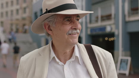 portrait of stylish elderly man smiling enjoying vacation sightseeing wearing white suit and hat travel tourism