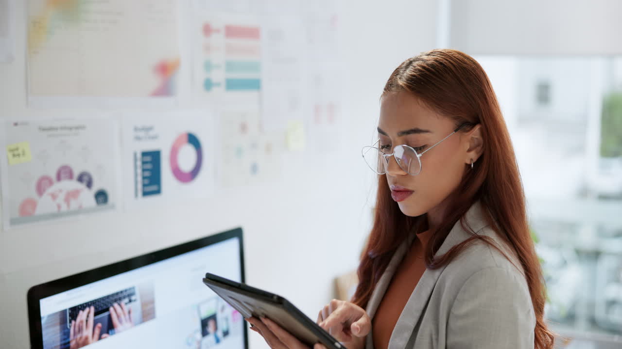 Woman working on tablet in office